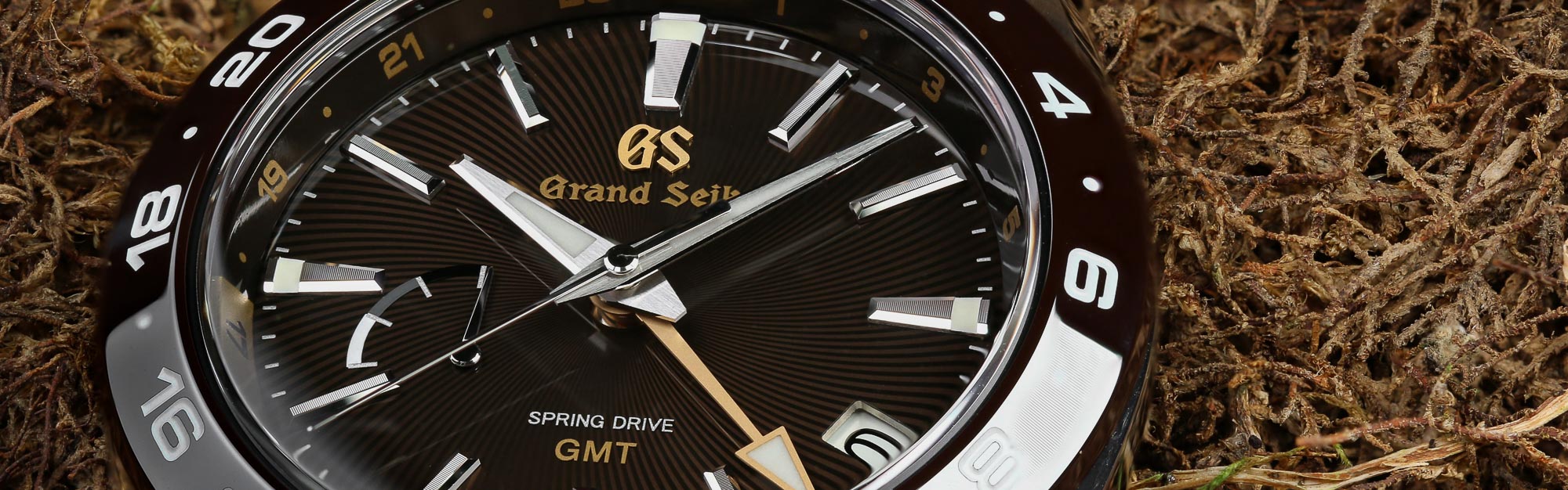 Grand Seiko SBGE263 brown dial sport watch with yellow accents.