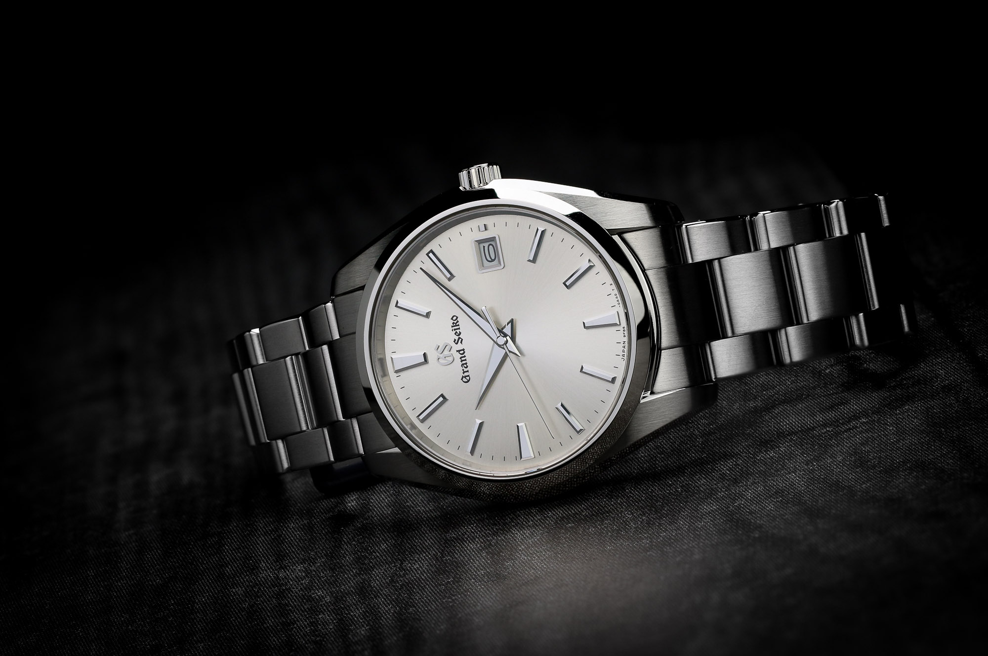 Grand Seiko SBGP009 stainless steel wristwatch with a light dial.