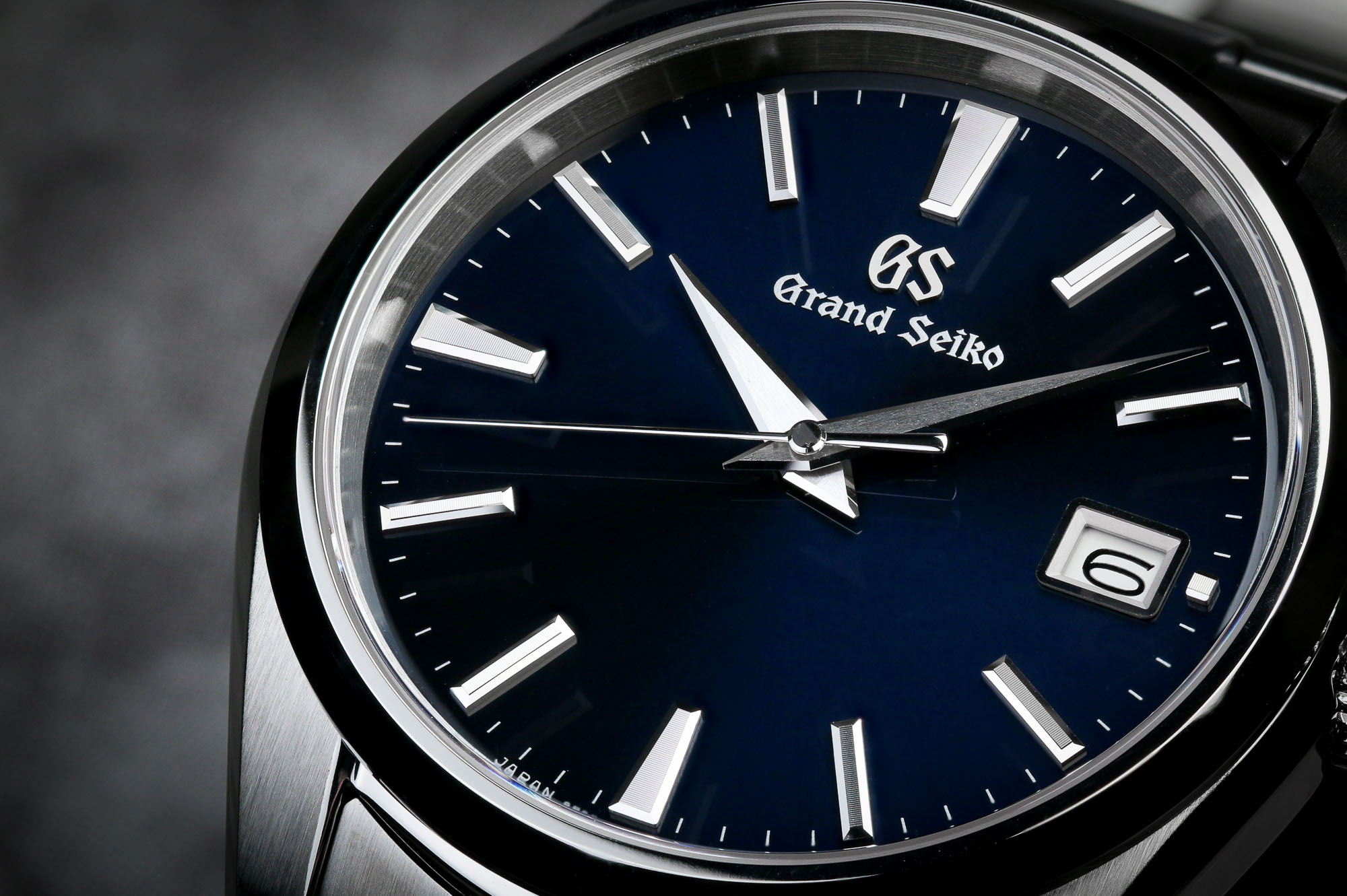 Grand Seiko SBGP013 stainless steel wristwatch with blue dial.