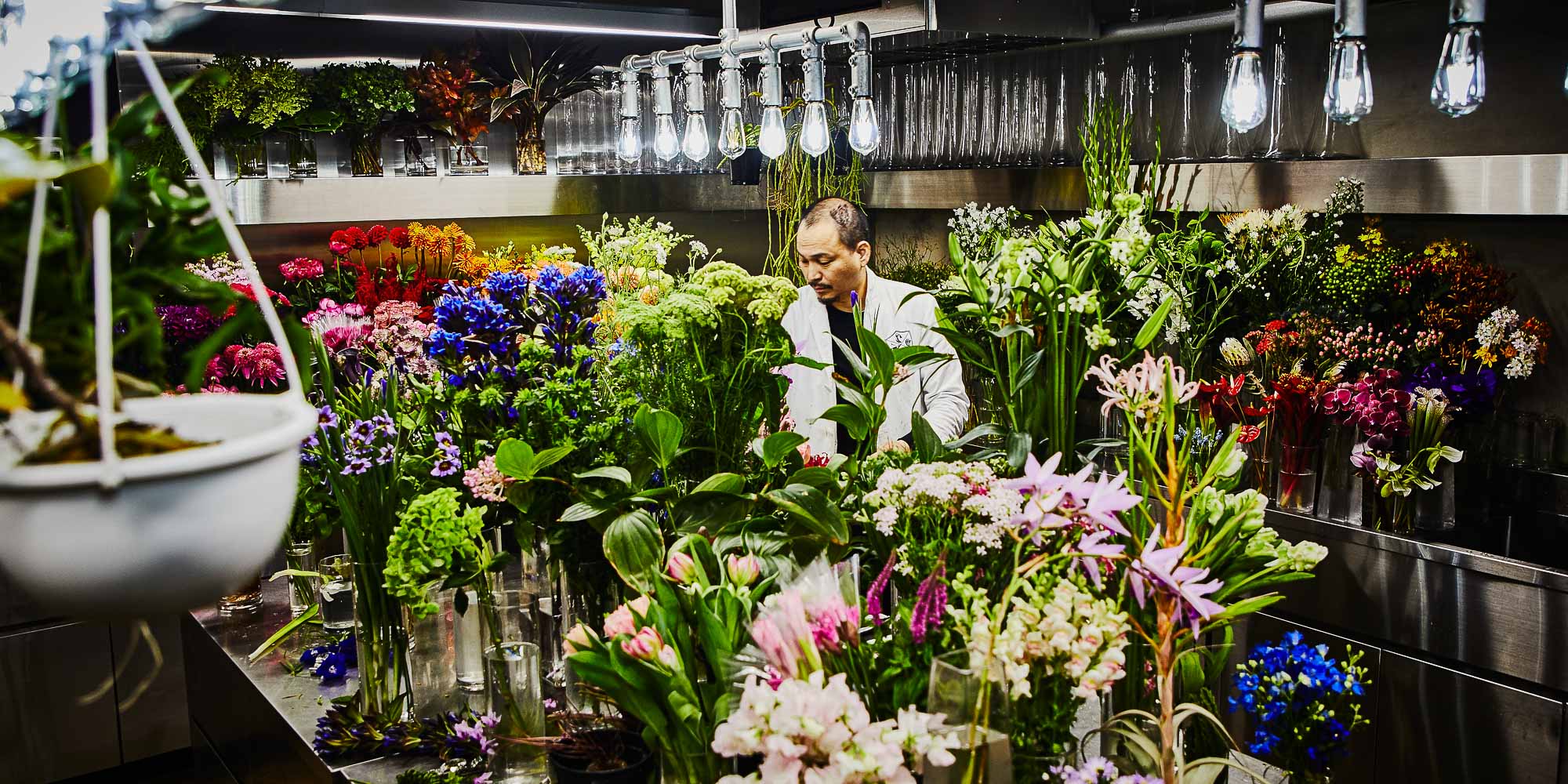 Makoto Azuma floral artist working in his workshop