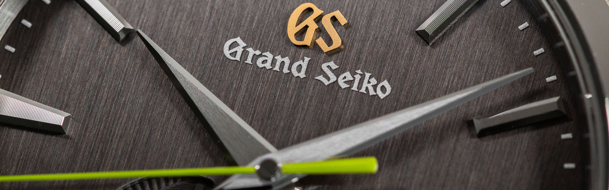 Macro of grey dial and logo of Grand Seiko SBGA429 wristwatch.