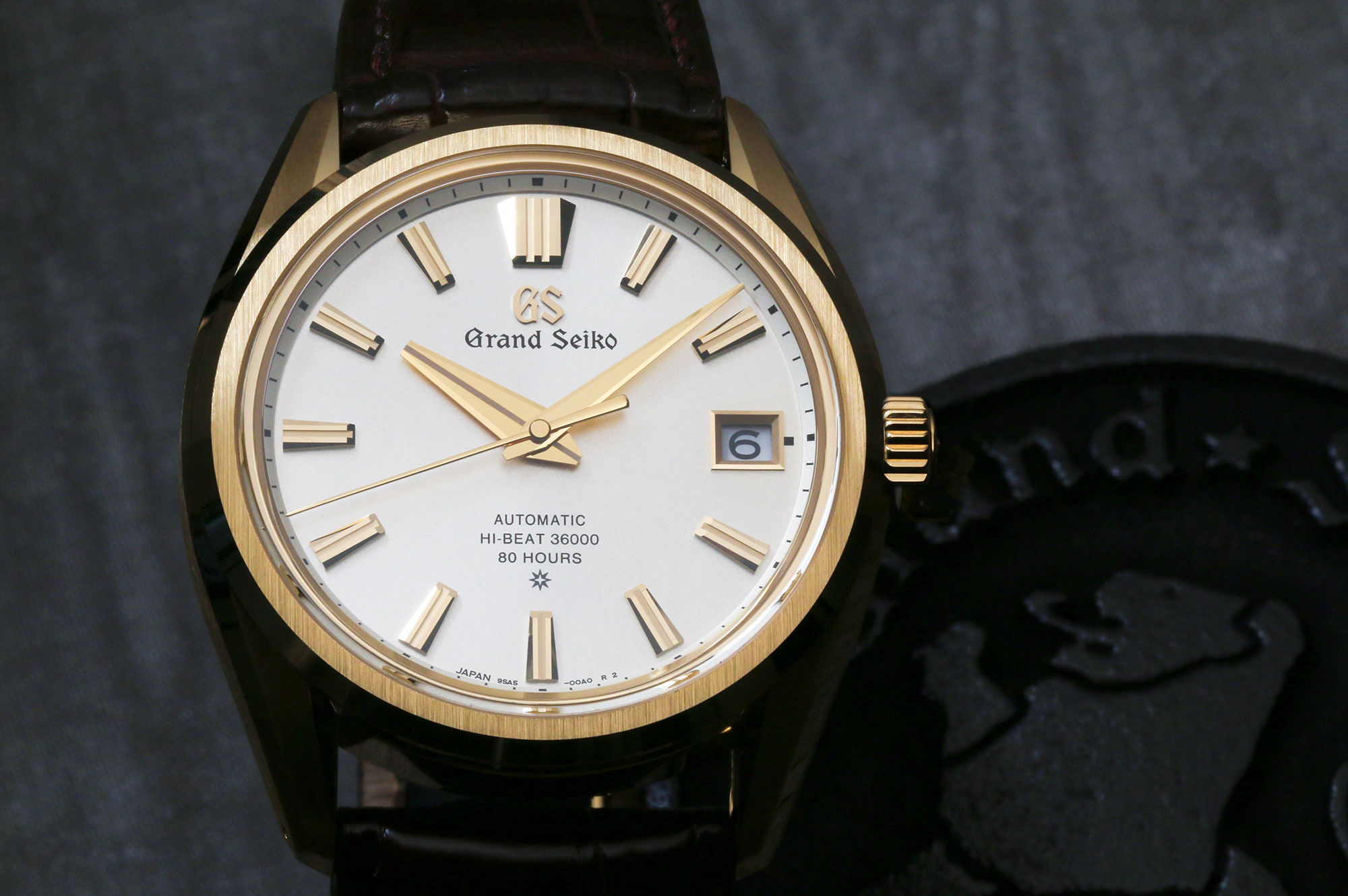 Grand Seiko SLGH002 with a gold case and light dial.