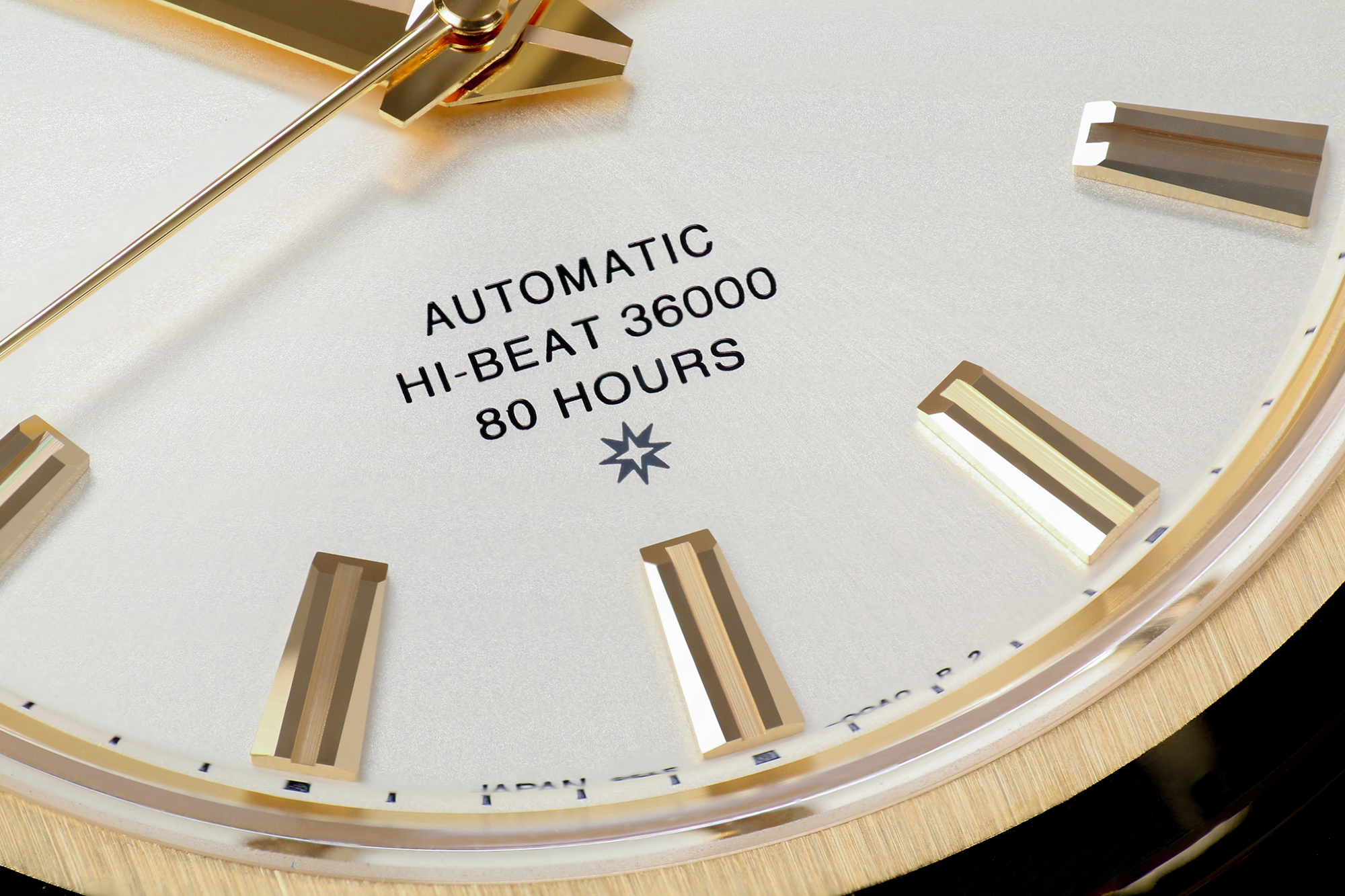 Grand Seiko SLGH002 with a gold case and light dial macro detail.