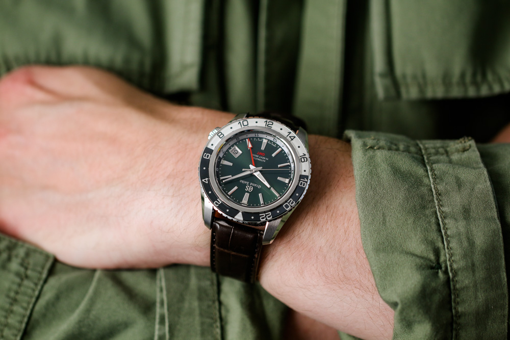 Grand Seiko SBGJ239 Hi-Beat GMT green-dial men's timepiece on wrist